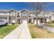 Beautiful townhome exterior featuring a stone facade, attached garages, and well-maintained landscaping on a sunny day at 4644 Craigmoss Ln, Charlotte, NC 28278