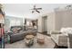 Inviting living room featuring a comfortable gray sofa, ceiling fan, and open access to the kitchen and dining area at 4644 Craigmoss Ln, Charlotte, NC 28278