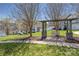 A swing set in a well-maintained community area surrounded by green lawns and residential homes at 4644 Craigmoss Ln, Charlotte, NC 28278