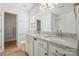 Bright bathroom features a double vanity with granite counters and a walk-in closet at 5291 Moonlight Sw Trl, Concord, NC 28025