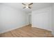 Bedroom featuring a closet, ceiling fan, and wood-look flooring at 5291 Moonlight Sw Trl, Concord, NC 28025
