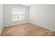 Cozy bedroom featuring a window for natural light and wood-look flooring at 5291 Moonlight Sw Trl, Concord, NC 28025
