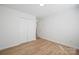 Bedroom featuring a closet for storage and wood-look flooring at 5291 Moonlight Sw Trl, Concord, NC 28025