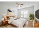 Inviting bedroom with light wood furnishings, a cozy rug, and large window at 5291 Moonlight Sw Trl, Concord, NC 28025