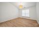 Bright bedroom with wood-look flooring and modern chandelier at 5291 Moonlight Sw Trl, Concord, NC 28025