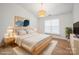 Bright bedroom features a large window, modern light fixture, and hardwood floors at 5291 Moonlight Sw Trl, Concord, NC 28025