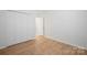 Bedroom featuring a closet for storage and wood-look flooring at 5291 Moonlight Sw Trl, Concord, NC 28025