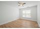 Bedroom featuring a window, ceiling fan, and wood-look flooring at 5291 Moonlight Sw Trl, Concord, NC 28025