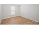 Bedroom featuring a window for natural light and wood-look flooring at 5291 Moonlight Sw Trl, Concord, NC 28025