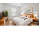 Bright bedroom featuring a queen-size bed, natural light, and a modern decor at 5291 Moonlight Sw Trl, Concord, NC 28025