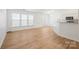 Bright open-concept living space with hardwood floors and a view of the kitchen at 5291 Moonlight Sw Trl, Concord, NC 28025