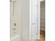 Clean bathroom featuring a shower over tub and white door to shelving at 5291 Moonlight Sw Trl, Concord, NC 28025