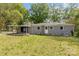 Spacious backyard featuring a covered patio, lush greenery, and convenient access to the home and outdoor amenities at 5323 Hilltop Cir, Charlotte, NC 28269