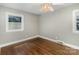 Cozy bedroom with hardwood floors and natural light; ceiling fan provides enhanced comfort at 5323 Hilltop Cir, Charlotte, NC 28269