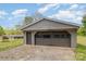 View of detached garage with spacious driveway and neutral siding, providing secure parking and storage solutions at 5323 Hilltop Cir, Charlotte, NC 28269