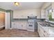 Functional kitchen featuring white cabinets, laminate countertops, and modern appliances, perfect for everyday cooking at 5323 Hilltop Cir, Charlotte, NC 28269