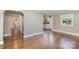 Open living area with hardwood floors that connects to the kitchen, hallway, and other living spaces at 5323 Hilltop Cir, Charlotte, NC 28269