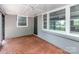 Bright sunroom featuring brick accents, large windows, and access to the outdoors, perfect for relaxation at 5323 Hilltop Cir, Charlotte, NC 28269