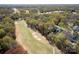 An aerial view of the home overlooking the lush, green golf course and mature trees in the Providence Country Club at 5419 Sunningdale Dr, Charlotte, NC 28277