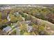 Aerial view showcases the home nestled among trees with the Waverly Town Center nearby at 5419 Sunningdale Dr, Charlotte, NC 28277