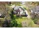 Aerial view of a brick home with a spacious yard, surrounded by mature trees at 5419 Sunningdale Dr, Charlotte, NC 28277