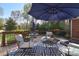 Outdoor seating area on a wooden deck, complete with a blue umbrella and potted flowers at 5419 Sunningdale Dr, Charlotte, NC 28277