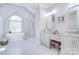 Luxurious bathroom featuring a soaking tub, glass-enclosed shower, and dual vanities with granite countertops at 5419 Sunningdale Dr, Charlotte, NC 28277