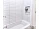 Bathroom showcasing clean white subway tiles, a shower niche, and a bathtub at 5419 Sunningdale Dr, Charlotte, NC 28277
