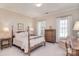 Bright bedroom featuring a four-poster bed, windows with curtains, and classic furnishings at 5419 Sunningdale Dr, Charlotte, NC 28277