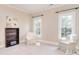 Bedroom with two large windows, a bookcase, and neutral decor providing a serene atmosphere at 5419 Sunningdale Dr, Charlotte, NC 28277