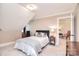 Bedroom with neutral walls, a bed with a plaid blanket, and an open doorway to another room at 5419 Sunningdale Dr, Charlotte, NC 28277