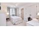 Cozy bedroom with white furniture, a chandelier, and a patterned curtain at 5419 Sunningdale Dr, Charlotte, NC 28277