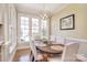 Bright dining room featuring a wooden table, white chairs, and large windows offering natural light at 5419 Sunningdale Dr, Charlotte, NC 28277