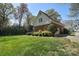 Side view of a two-story home with a brick exterior, attached garage, and green lawn at 5419 Sunningdale Dr, Charlotte, NC 28277
