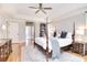 Bright main bedroom with four-poster bed, hardwood floors, and ensuite bathroom access at 5419 Sunningdale Dr, Charlotte, NC 28277