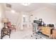 Bright office with a wooden desk, chair, and an open doorway to a bedroom at 5419 Sunningdale Dr, Charlotte, NC 28277