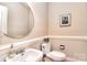 Cozy powder room with a pedestal sink, round mirror, and a traditional toilet at 5419 Sunningdale Dr, Charlotte, NC 28277