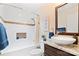 Updated bathroom featuring white marble tiling, a tub and shower combo, and a vanity sink with granite countertops at 552 Odell School Rd, Concord, NC 28027
