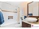 Well-lit bathroom featuring a tub, a vessel sink with granite counter, and a decorative accent mirror at 552 Odell School Rd, Concord, NC 28027