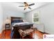 A relaxing bedroom with a large bed, wood floors, and light blue walls at 552 Odell School Rd, Concord, NC 28027