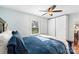 A cozy bedroom is brightly lit by the window, showcasing a blue comforter, closet, and hardwood floors at 552 Odell School Rd, Concord, NC 28027