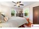 Comfortable bedroom with windows bringing in light, ceiling fan, and wooden wardrobe at 552 Odell School Rd, Concord, NC 28027