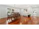 Sunlit dining room featuring elegant chandelier, hardwood floors, and a cozy ambiance at 552 Odell School Rd, Concord, NC 28027