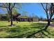 Charming single-story home with a manicured front lawn, mature trees, and attached garage at 552 Odell School Rd, Concord, NC 28027