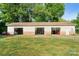 Large three-car garage with brick facade and ample storage, perfect for a workshop or hobby space at 552 Odell School Rd, Concord, NC 28027