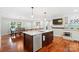 Spacious kitchen with an island, stainless steel appliances, and an open dining area with lots of natural light at 552 Odell School Rd, Concord, NC 28027