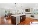 A spacious kitchen area with a large island, white countertops, and stainless steel appliances at 552 Odell School Rd, Concord, NC 28027