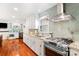 Modern kitchen boasts stainless steel appliances, granite countertops, and a stylish tile backsplash at 552 Odell School Rd, Concord, NC 28027