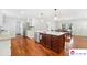 Spacious kitchen features large island, wood floors, and stainless steel dishwasher at 552 Odell School Rd, Concord, NC 28027