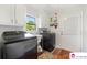 Bright laundry room features modern washer and dryer, utility sink, and storage cabinets at 552 Odell School Rd, Concord, NC 28027